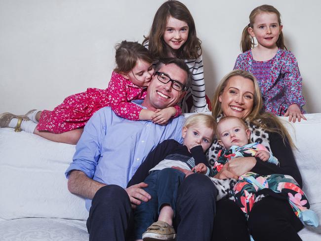 Dominic Perrottet at home with his wife Helen and children Harriet, 8 months, William 2, Annabelle, 4, Amelia, 6, and Charlotte, 8. Picture: Jenny Evans