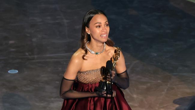 An emotional Zoe Saldana accepts the Best Actress in a supporting role Oscar for ‘Emilia Perez’. Picture: Kevin Winter/Getty Images