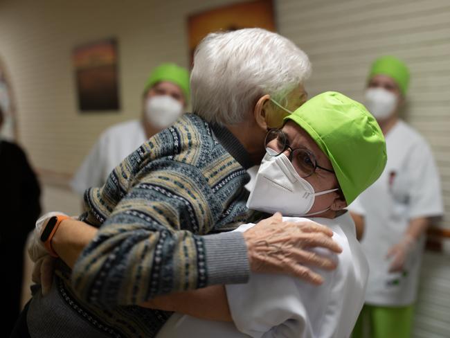 Lidia Navarro, 84, is hugged by a nurse before becoming one of the first to receive the vaccine in Spain. Picture: Getty Images