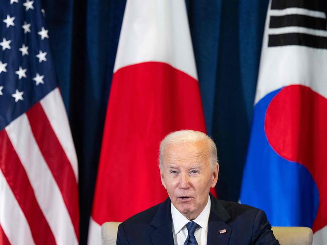 US President Joe Biden speaks during a trilateral meeting with Japanese Prime Minister Ishiba Shigeru and South Korean President Yoon Suk Yeol on the sideline of the Asia-Pacific Economic Cooperation (APEC) summit in Lima, Peru, November 15, 2024. (Photo by SAUL LOEB / AFP)