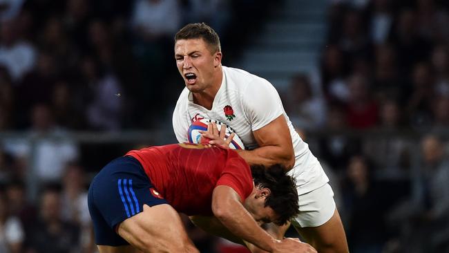 Sam Burgess of England is tackled by Remi Lamerat of France.