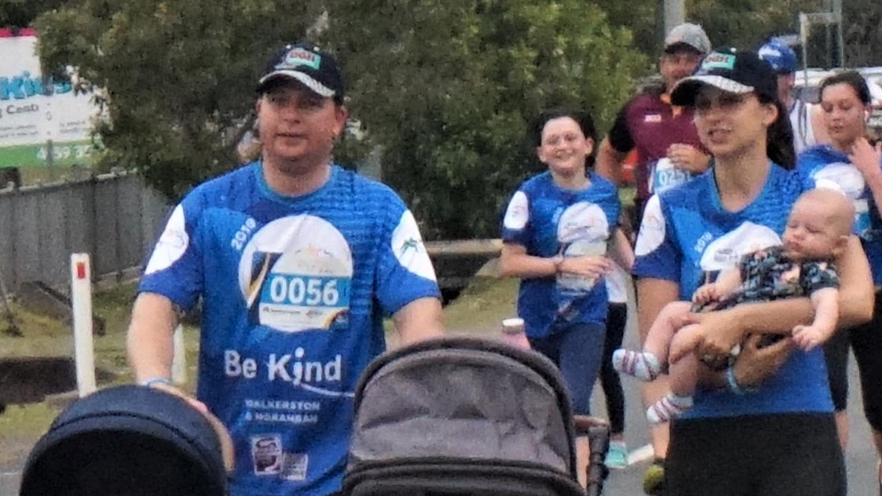 Joshua Camm has charge of the strollers, while the rest of the family strolls though the walk.