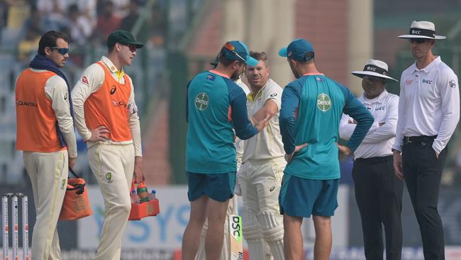 David Warner gets medical aid during the first day of the second Test. Picture: AFP