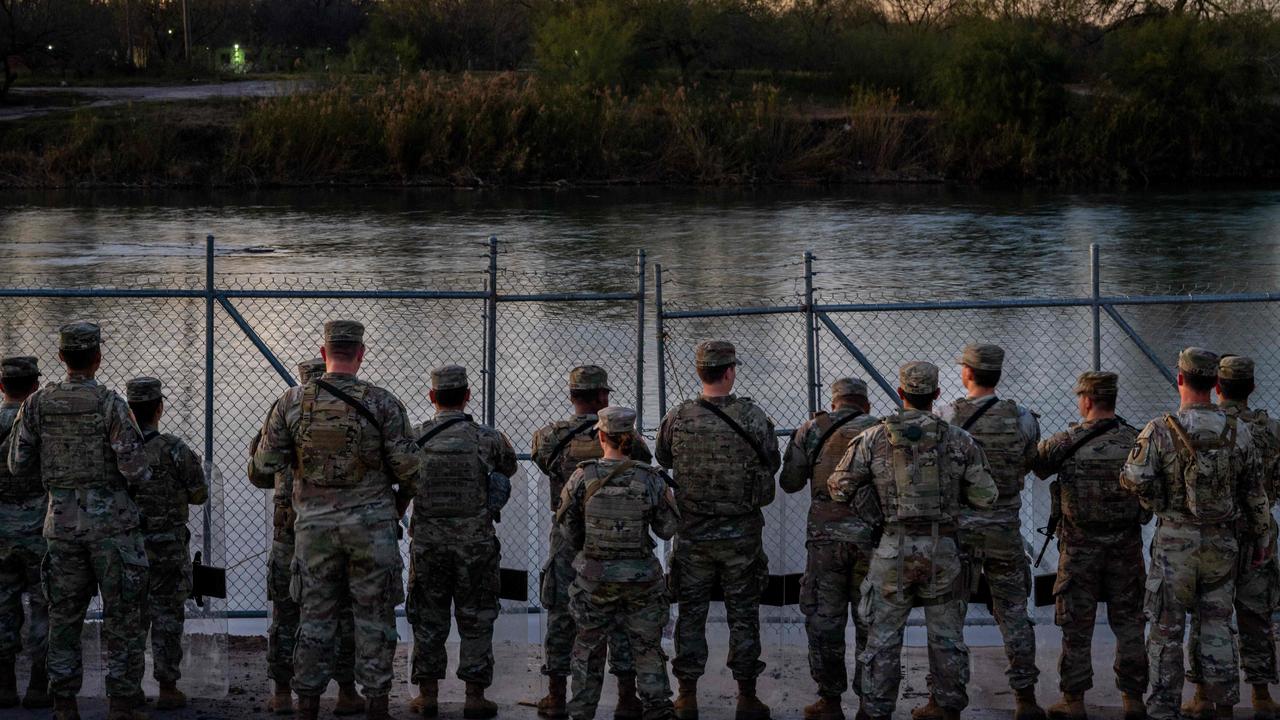 Texas National Guard soldiers stand guard on the banks of the Rio Grande river at Shelby Park on January 12, 2024 in Eagle Pass, Texas. (Photo by Brandon Bell / GETTY IMAGES NORTH AMERICA / Getty Images via AFP)