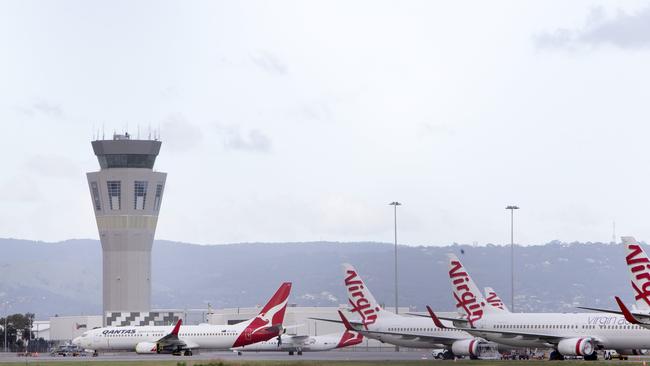 Qantas and Virgin planes lying dormant at Adelaide Airport in June last year. Picture: Emma Brasier