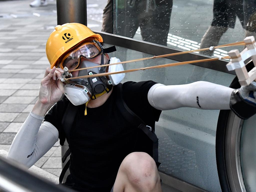 A protester uses an improvised slingshot at police in the Admiralty area. Picture: AFP