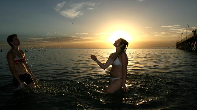 Hot weather Glenelg Beach, Adelaide Krystle Dalton (040236554) and Alica Maio from Darwin NT cooling off in the hot weather.