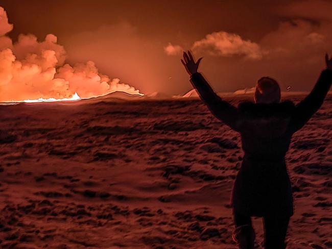 A local resident watches smoke billow. Picture: Kristin Elisabet Gunnarsdottir/AFP