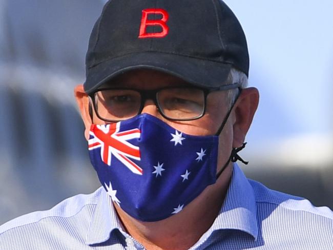 POOL - Australian Prime Minister Scott Morrison wears a face mask as he disembarks a plane after landing at Longreach Airport in Longreach, Queensland, Tuesday, January 19, 2021. Australian Prime Minister Scott Morrison is on a 4 day visit to regional Queensland. Picture: AAP Image/Lukas Coch/POOL via NCA NewsWire