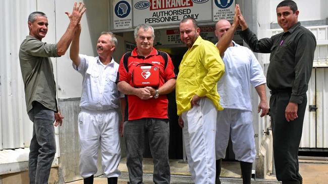 Dave Carroll in the centre holding the defibrillator, with the men who saved his life- Darren Grimston, Darrell Schultz, Jason Keep, Luke Murphy and Steve Formaggian outside the boning room at Casino's NCMC. Picture: Susanna Freymark