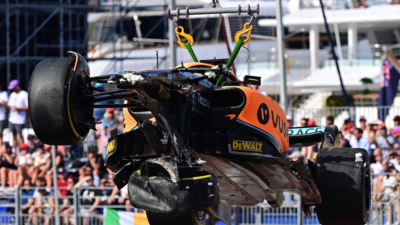 The car of McLaren's Australian driver Daniel Ricciardo is lifted off the course after he crashed during the second practice session at the Monaco street circuit in Monaco, ahead of the Monaco Formula 1 Grand Prix, on May 27, 2022. (Photo by ANDREJ ISAKOVIC / AFP)