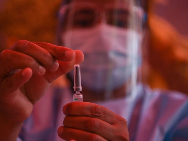 A health worker shows a pre-filled syringe of the Chinese-made Vero Cell Covid-19 vaccine in Kathmandu on June 10, 2021. (Photo by PRAKASH MATHEMA / AFP)