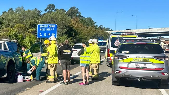 Paramedics treating patients at the scene of the accident. Picture: QAS