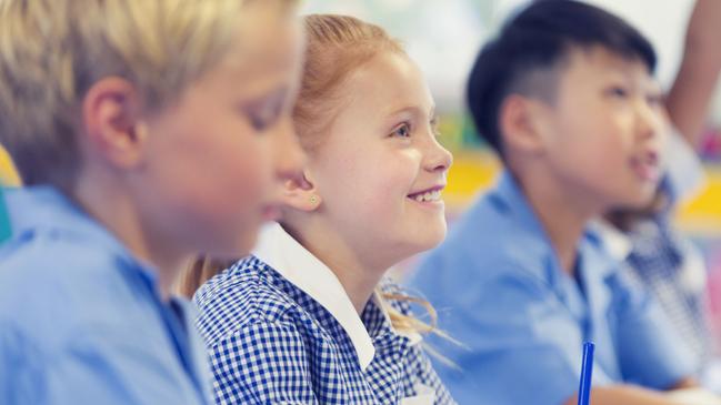 Generic photo of happy students in their classroom wearing their school uniform