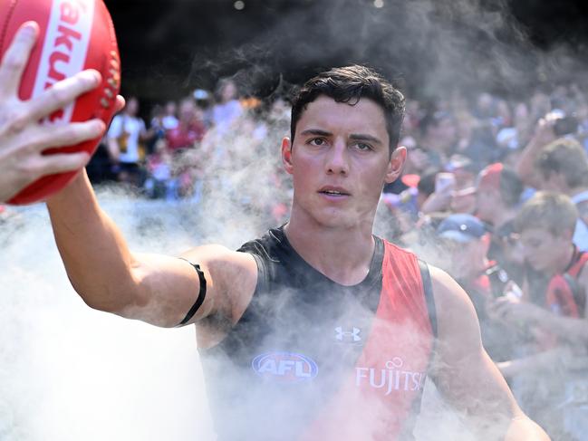 MELBOURNE, AUSTRALIA - MARCH 16: Jye Caldwell of the Bombers runs out onto the field during the round one AFL match between Essendon Bombers and Hawthorn Hawks at Melbourne Cricket Ground, on March 16, 2024, in Melbourne, Australia. (Photo by Quinn Rooney/Getty Images)