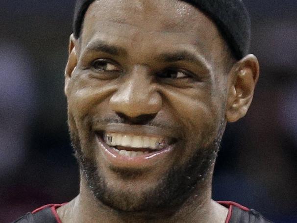 FILE - In this April 28, 2014, file photo, Miami Heat's LeBron James smiles as he walks down the court during the second half in Game 4 of an opening-round NBA basketball playoff series against the Charlotte Bobcats in Charlotte, N.C. "Commissioner Silver thank you for protecting our beautiful and powerful league!! Great leader!! #BiggerThanBasketball #StriveForGreatness," James wrote on Twitter Tuesday, April 29, 2014, after Silver announced that Los Angeles Clippers owner Donald Sterling has been banned for life by the league, in response to racist comments the league says he made in a recorded conversation. (AP Photo/Chuck Burton, File)