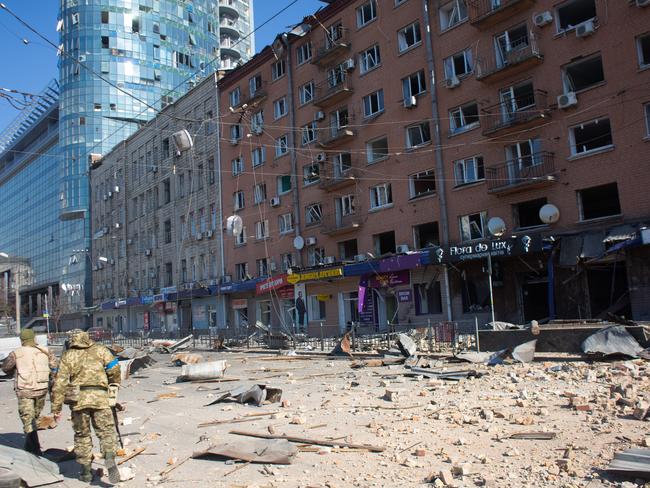 Ukrainian servicemen are seen by the building which got shelled near Lukyanivska metro station on March 14, 2022 in Kyiv, Ukraine. Picture: Getty Images