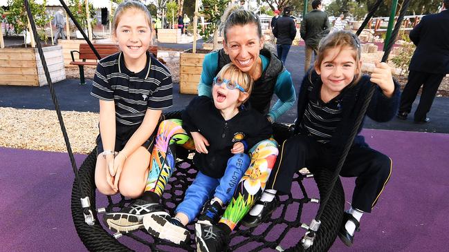 Marianne Sankey with Tahlia, 9, twins Aaron and Maddie, 5, at the new playground in Park Holme. Picture: AAP/Mark Brake