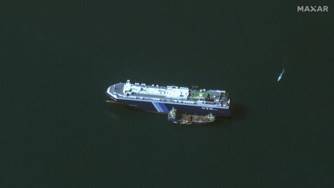 This handout satellite picture released by Maxar Technologies shows the recently seized Israeli-linked Galaxy Leader cargo ship, that was captured by Houthi fighters, next to a support vessel in the southern Red Sea near Hodeida, Yemen. Picture via AFP