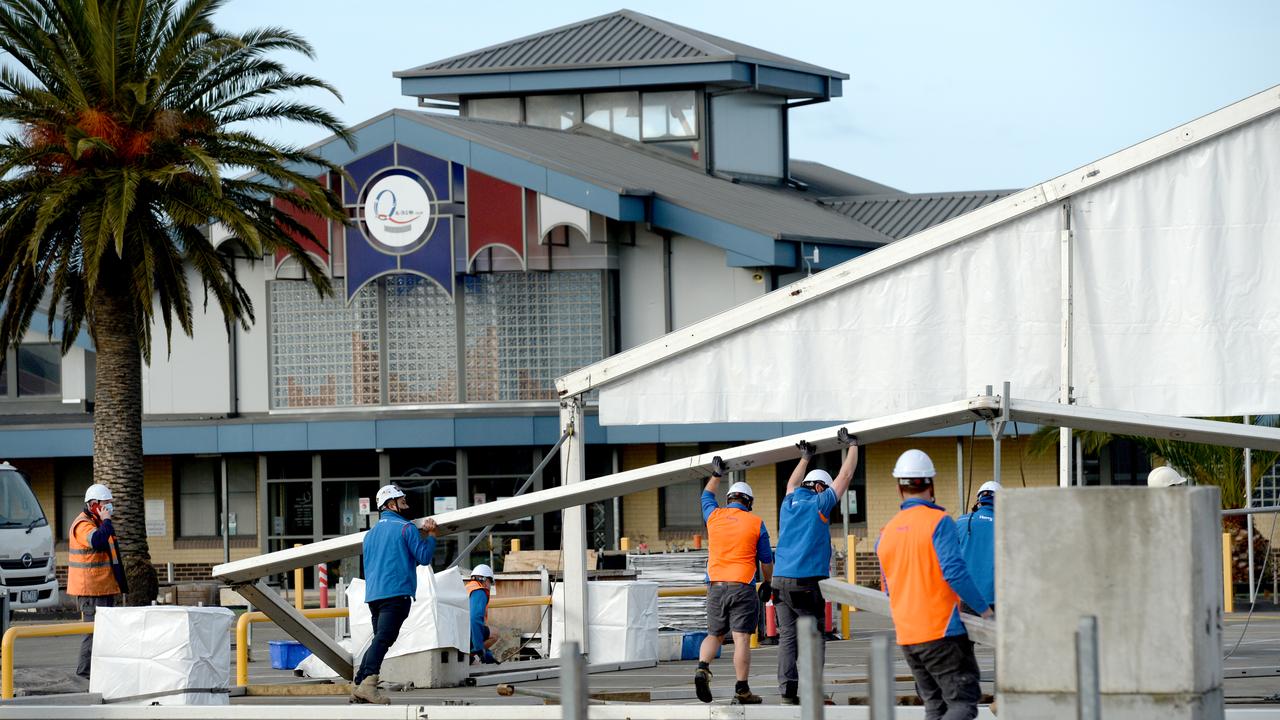 Workmen erect a temporary testing centre at Al-Taqwa College in Truganina after a teacher at the school tested positive to Covid-19. Picture: Andrew Henshaw