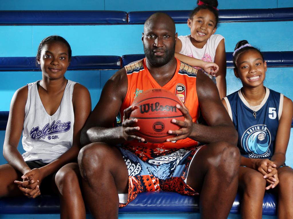 Nate Jawai shows off the special Indigenous jersey and shorts the Taipans will be wearing for the NBL Indigenous round with his niece Teyahua Bond, 13, daughter Kayah, 6, and niece Taryn Bond, 11. Picture: Stewart McLean