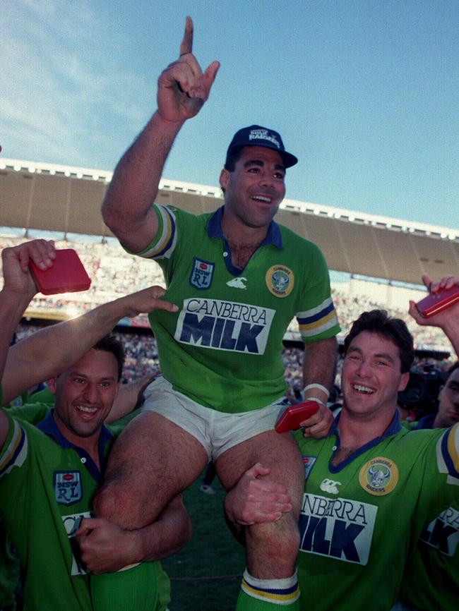 Canberra Raiders players Laurie Daley and Bradley Clyde hoist captain Mal Meninga after their Grand Final win 1994.