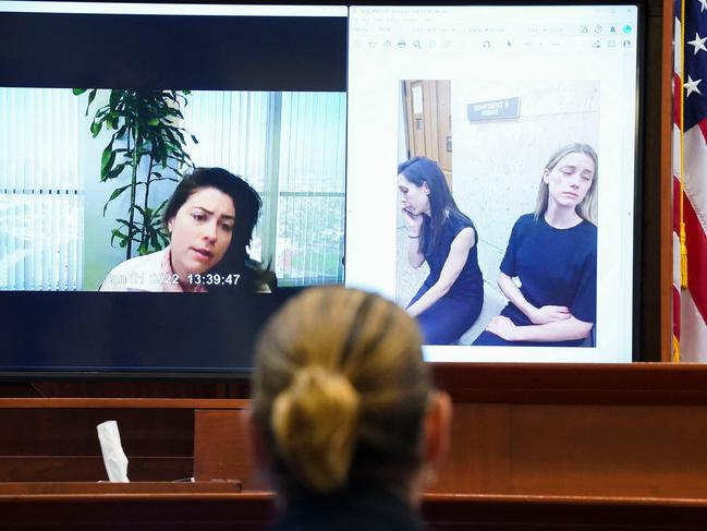 Johnny Depp, centre (from back) as Raquel Pennington testifies in a previously recorded video deposition. Picture: AFP