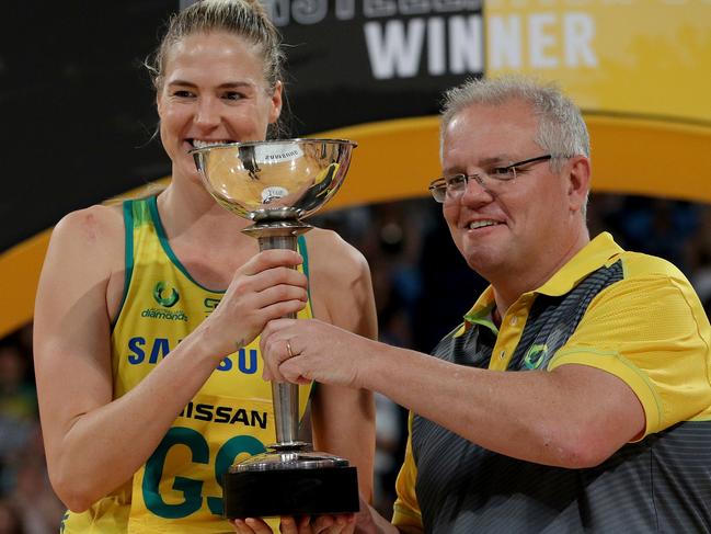 Prime Minister Scott Morrison presents the Constellation Cup to Caitlin Bassett of Australia after Game Four of the Constellation Cup between Australia and New Zealand at RAC Arena in Perth, Sunday, October 27, 2019. (AAP Image/Richard Wainwright) NO ARCHIVING