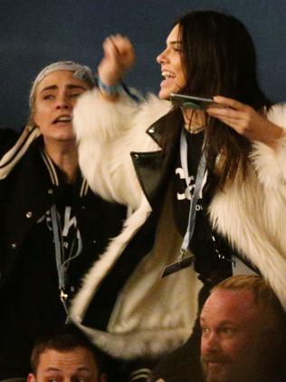 Kendall Jenner (right) and Cara Delevingne watching Kanye West performing on The Pyramid Stage at the Glastonbury Festival, at Worthy Farm in Somerset.. Picture date: Saturday June 27, 2015. Photo credit should read: Yui Mok/PA Wire