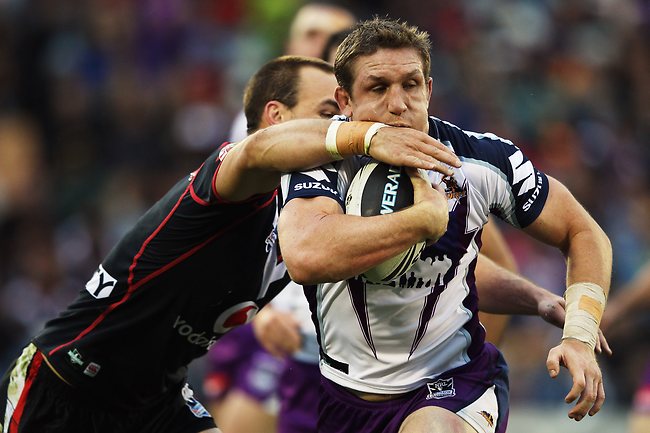 <p>Warriors v Storm: Ryan Hoffman of the Storm is tackled by Simon Mannering of the Warriors.</p>