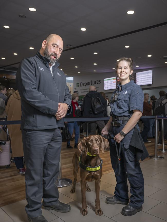 Hobart Airport and Biosecurity Tasmania – Justin Helmich Director of Biosecurity Operations and Lillian Burbury Detector Dog Handler with Toby. Picture: Caroline Tan