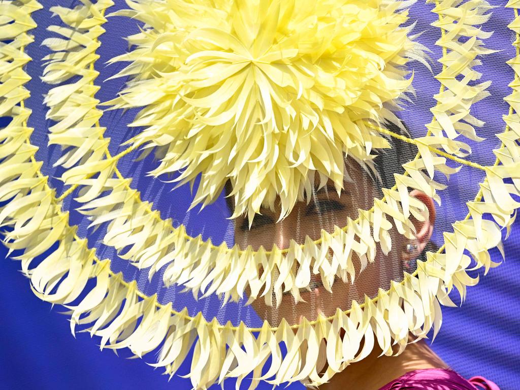 Headwear is a great way to express yourself at the races (and escape the sun). Photo by William WEST / AFP