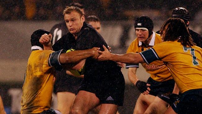 NEW ZEALAND - JULY 13: All Black Scott Robertson breaks through the Wallabies defence in the TriNations rugby match at Jade Stadium, Christchurch, Saturday. The All Blacks won 126. (Photo by Ross Land/Getty Images)