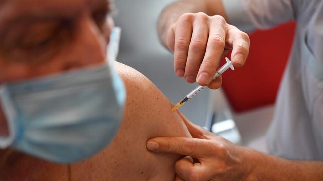 An elderly man receives a dose of the Pfizer-BioNtech Covid-19 vaccine, at a vaccination centre in Quimper, western France, on February 16, 2021. (Photo by Fred TANNEAU / AFP)