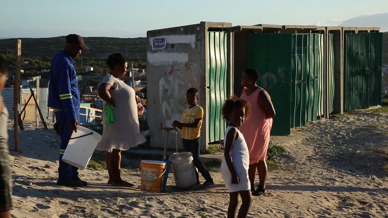 A boy in Khayelitsha fills up his bucket with precious water. Picture: SBS