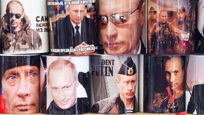 The many faces of Vladimir Putin, as seen on cups for sale in Saint Petersburg.