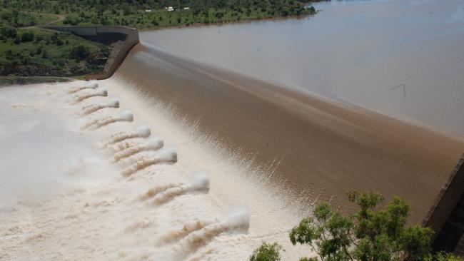 Water flows over the spillway of the Burdekin Falls Dam.