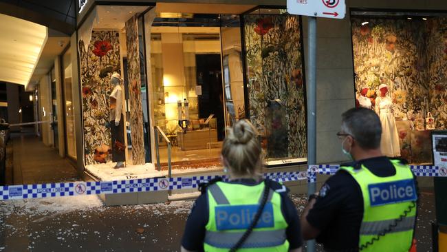 Police survey the damage on Collins St. Picture: NCA NewsWire/David Crosling