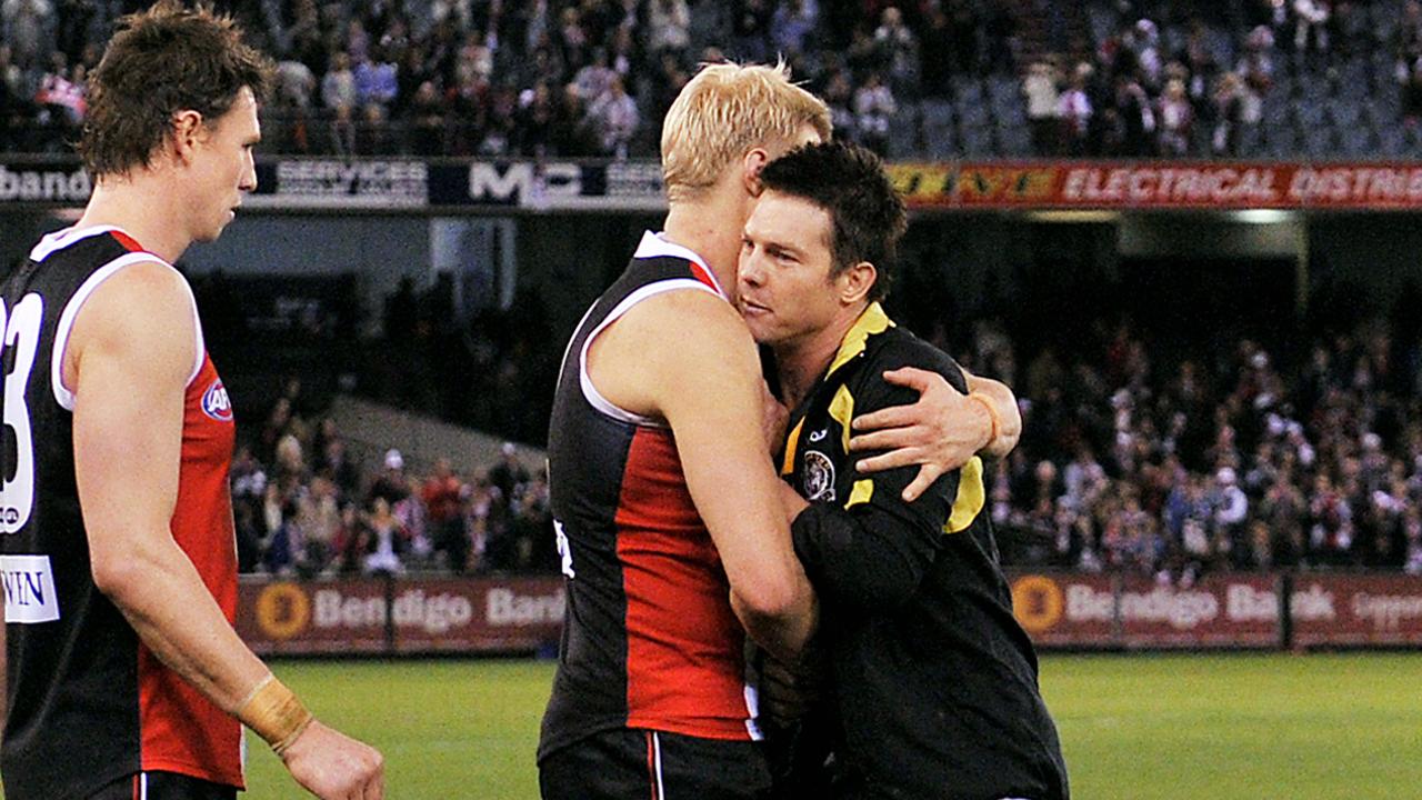 Nick Riewoldt and Ben Cousins embrace at the end of a match.