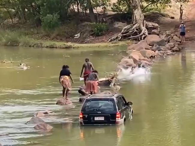 A bunch of crocheads who got bogged at Cahills Crossing walked across the infamous body of water to get out, with one slipping in. PICTURE: SUPPLIED