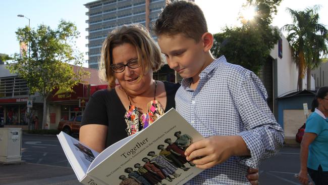 Clare Jones and son Oliver looking over the book Together, The Country Women’s Association of the Northern Territory