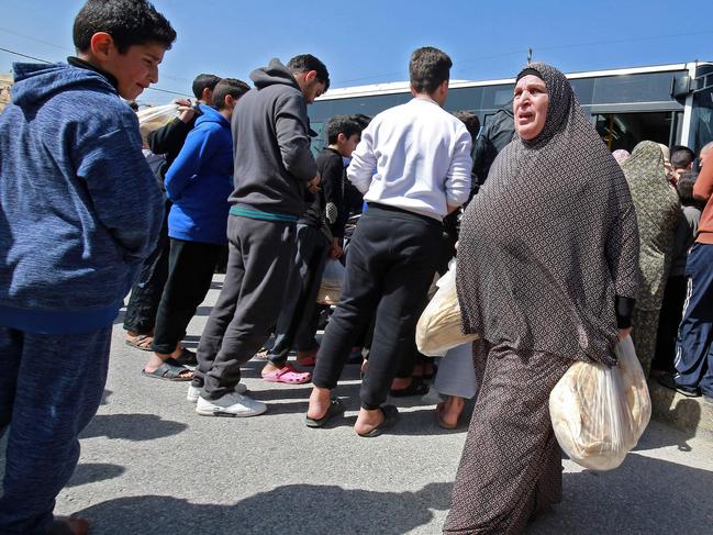 People queue to buy subsidised bread from a municipal bus in the Marka suburb in the east of Jordan's capital Amman. Picture: AFP