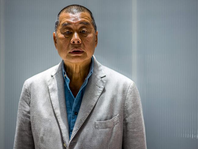 (FILES) In this file photo taken on June 16, 2020, millionaire media tycoon Jimmy Lai, 72, poses during an interview with AFP at the Next Digital offices in Hong Kong. - Lai appeared in court on December 3, 2020 charged with fraud, the latest in a string of prosecutions brought against high profile Beijing critics and democracy campaigners. (Photo by Anthony WALLACE / AFP)