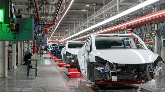 Cars on the assembly line during a tour of the Tesla Giga Texas manufacturing facility.