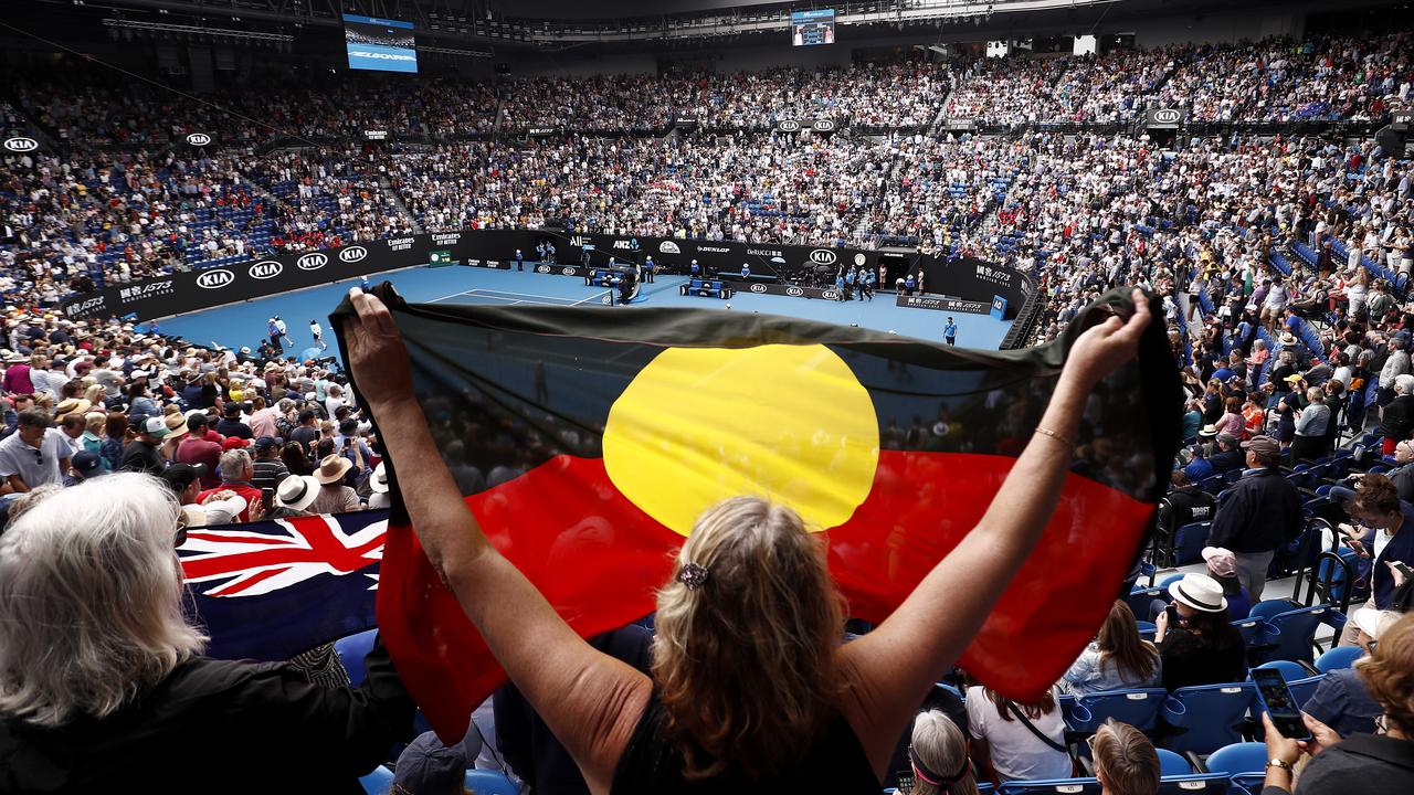 A spectator in the crowd holds up an Indigenous flag at the Australian Open at Melbourne Park . (Photo by Darrian Traynor/Getty Images)