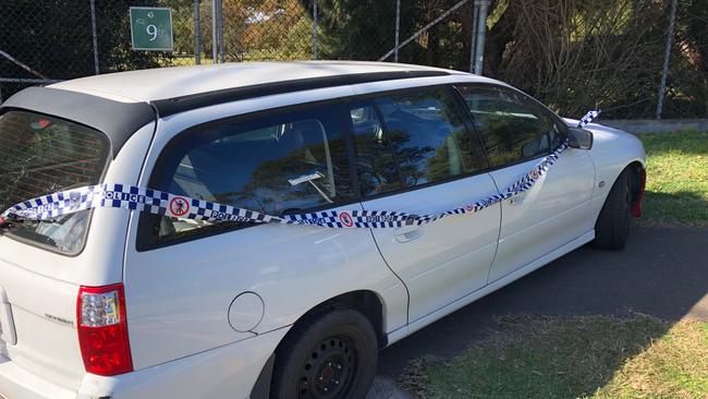 Police tape around the damaged Commodore abandoned in Quirk Rd, Manly Vale. Picture: Jim O'Rourke