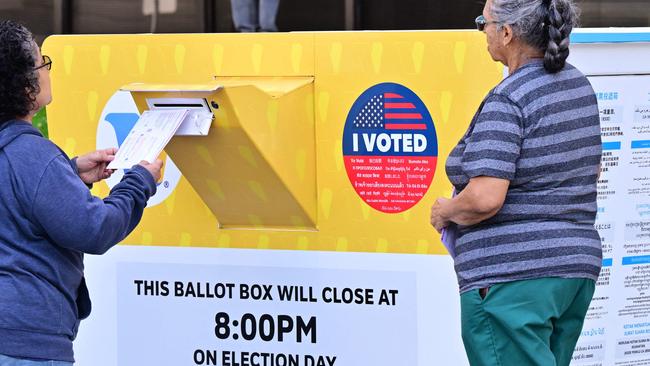 Women drop off their ballots into a ballot box in Norwalk, California. Picture: AFP.