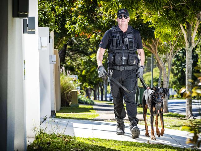 Security guard Wayne Heneker and his dog 'Boss', who has been hired by Gold Coast residents to patrol their suburbs. Picture: NIGEL HALLETT