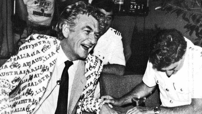 The utter joy of that America’s Cup victory is hard to convey to anyone who did not experience it, writes Chris Kenny. Pictured: Bob Hawke shares the moment of victory with flag officers of the Royal Perth Yacht Club in September 1983.