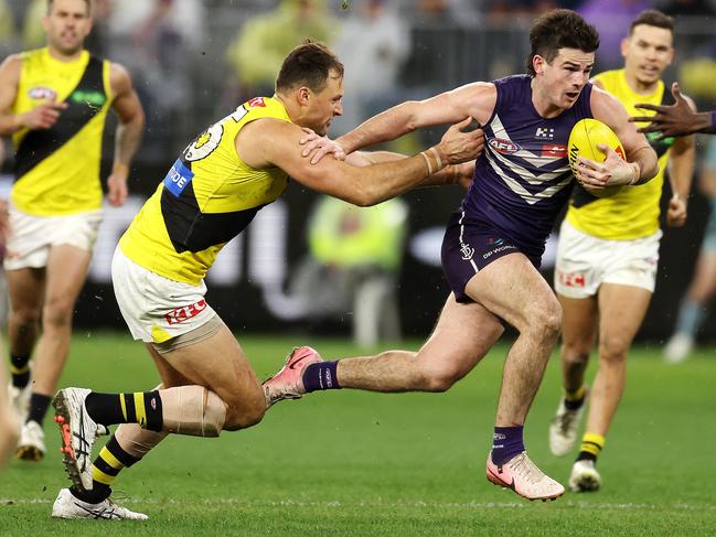 PERTH, AUSTRALIA - JULY 06: Andrew Brayshaw of the Dockers fends off Toby Nankervis of the Tigers during the 2024 AFL Round 17 match between the Fremantle Dockers and the Richmond Tigers  at Optus Stadium on July 06, 2024 in Perth, Australia. (Photo by Will Russell/AFL Photos via Getty Images)